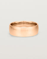 The front view of a heavy 7mm wedding band in rose gold