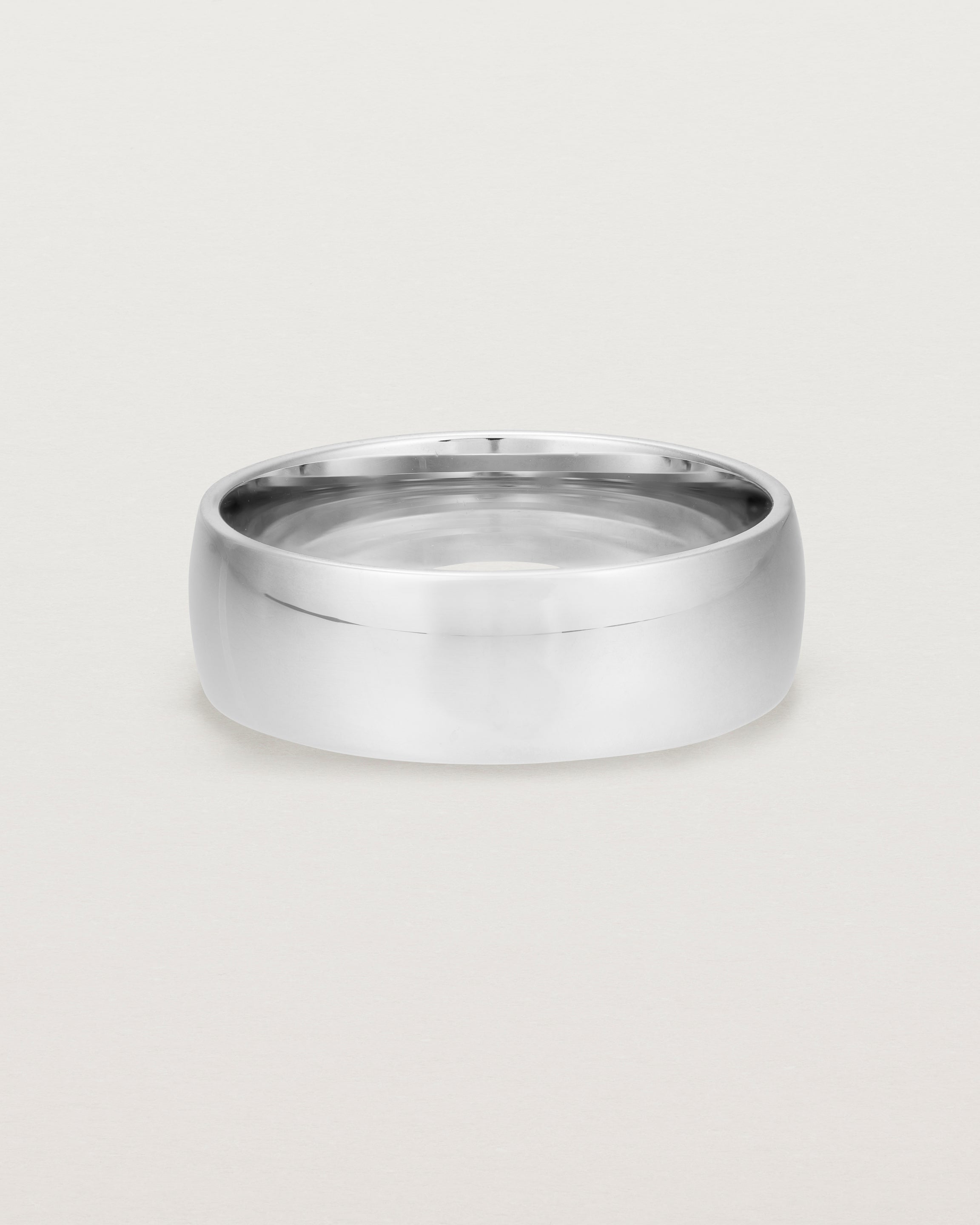 The front view of a heavy 7mm wedding band in white gold