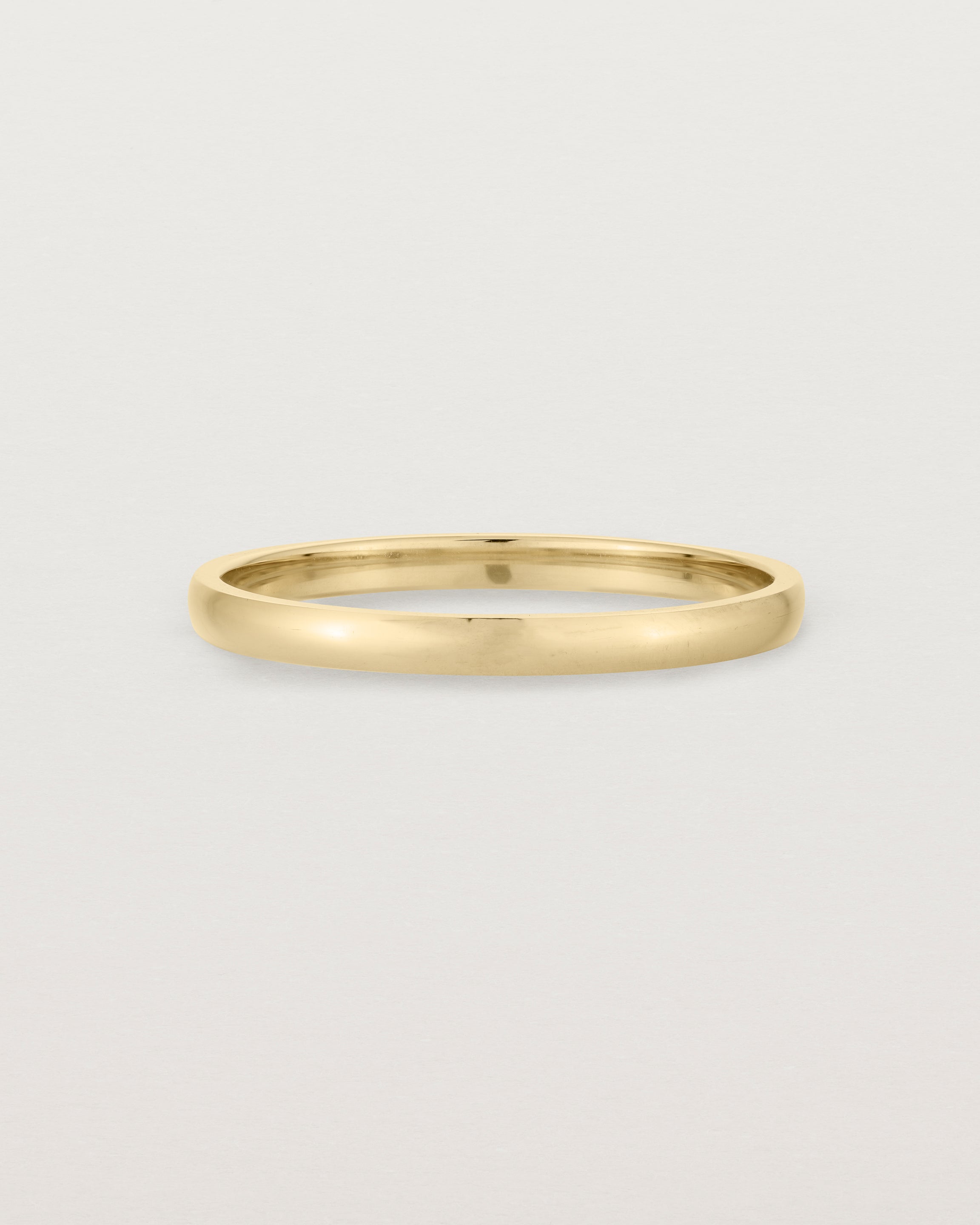 A fine, classic wedding band in yellow gold