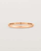 A fine, classic wedding band in rose gold