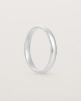 The side view of a 3mm fine, classic wedding band in white gold