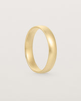 A classic 4mm wedding band crafted in yellow gold