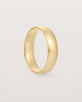 A classic 5mm wedding band, our most popular width, crafted in yellow gold