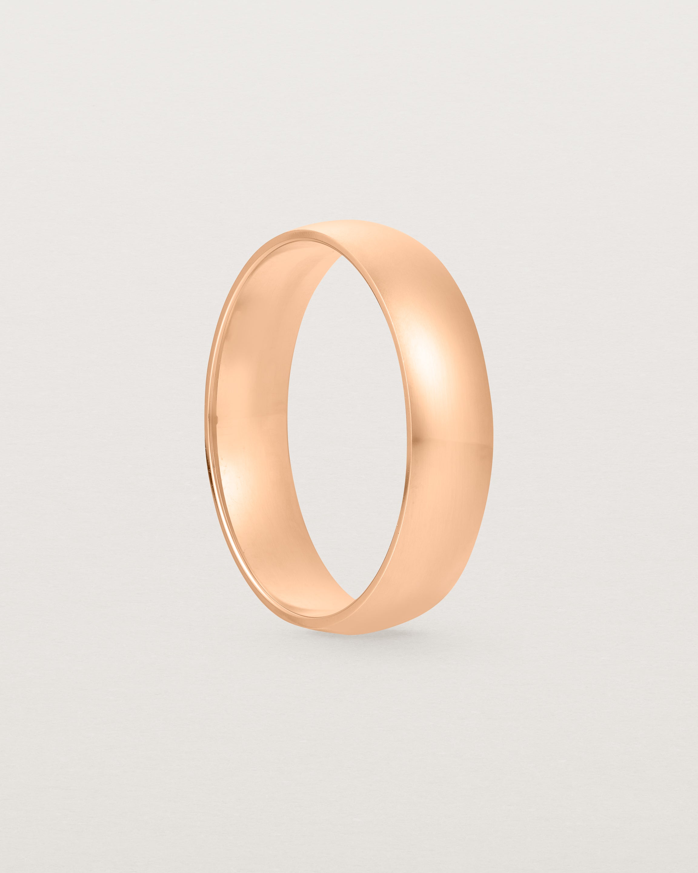 A 5mm wedding band, our most popular width, crafted in rose gold.