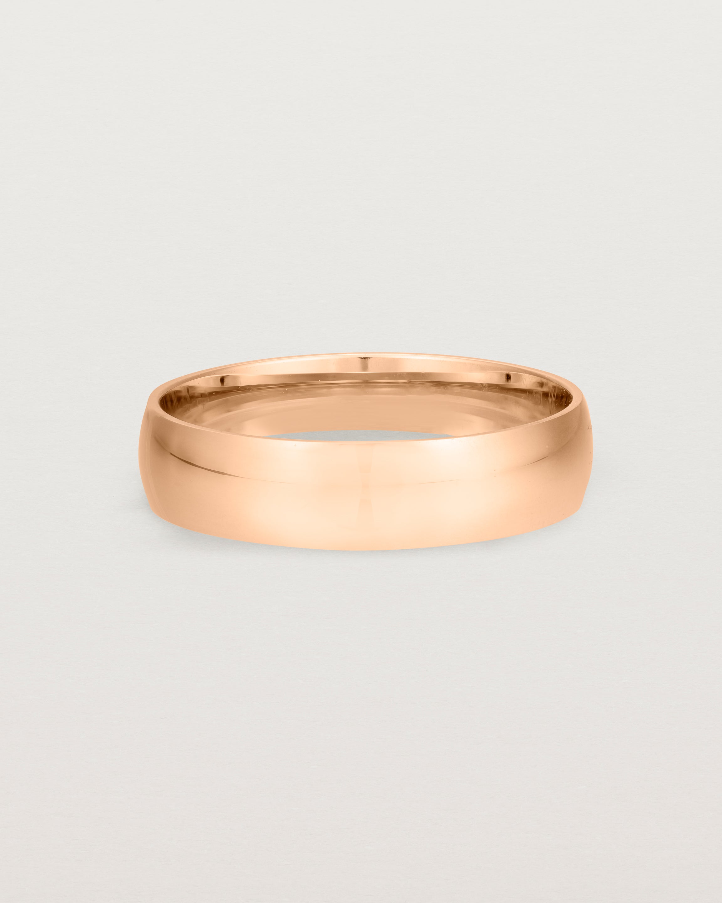 A 5mm wedding band, our most popular width, crafted in rose gold.