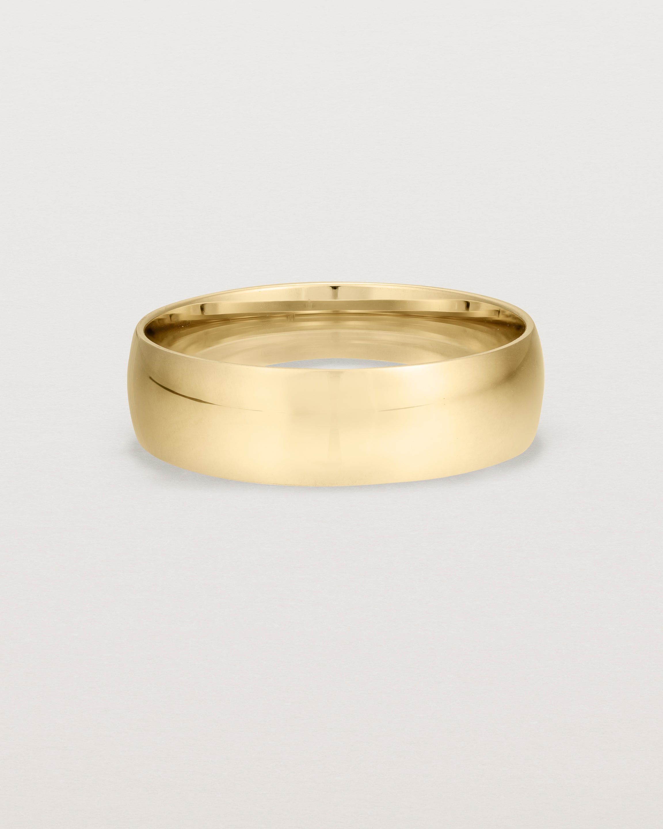 A bold 6mm wedding band crafted in yellow gold