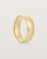 A bold 6mm wedding band crafted in yellow gold
