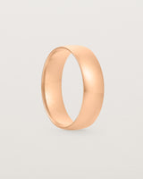 A bold 6mm wedding band crafted in rose gold