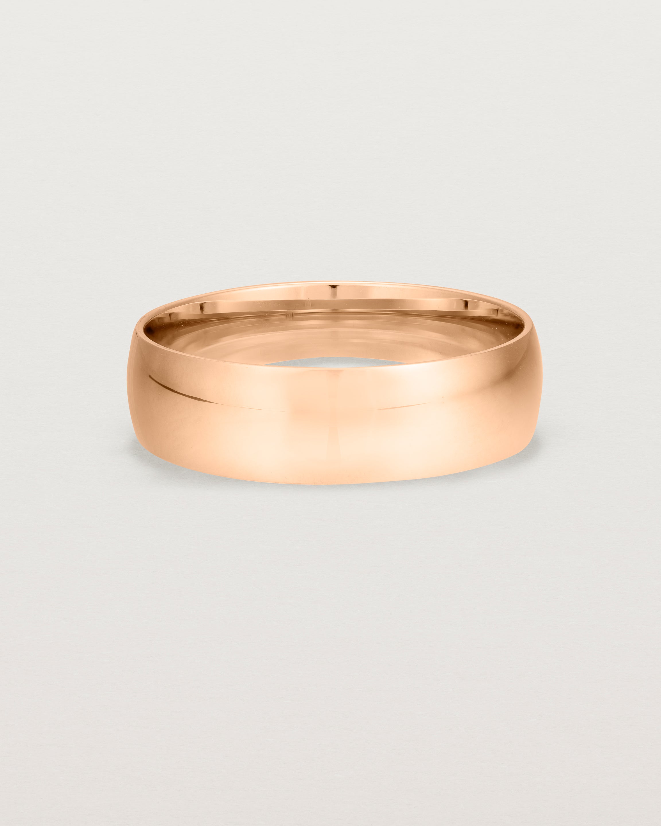 A bold 6mm wedding band crafted in rose gold