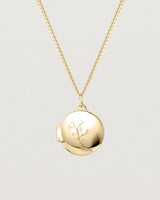 Front view of the Clematis Vine Locket in yellow gold.