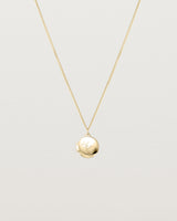 Front view of the Clematis Vine Locket in yellow gold.