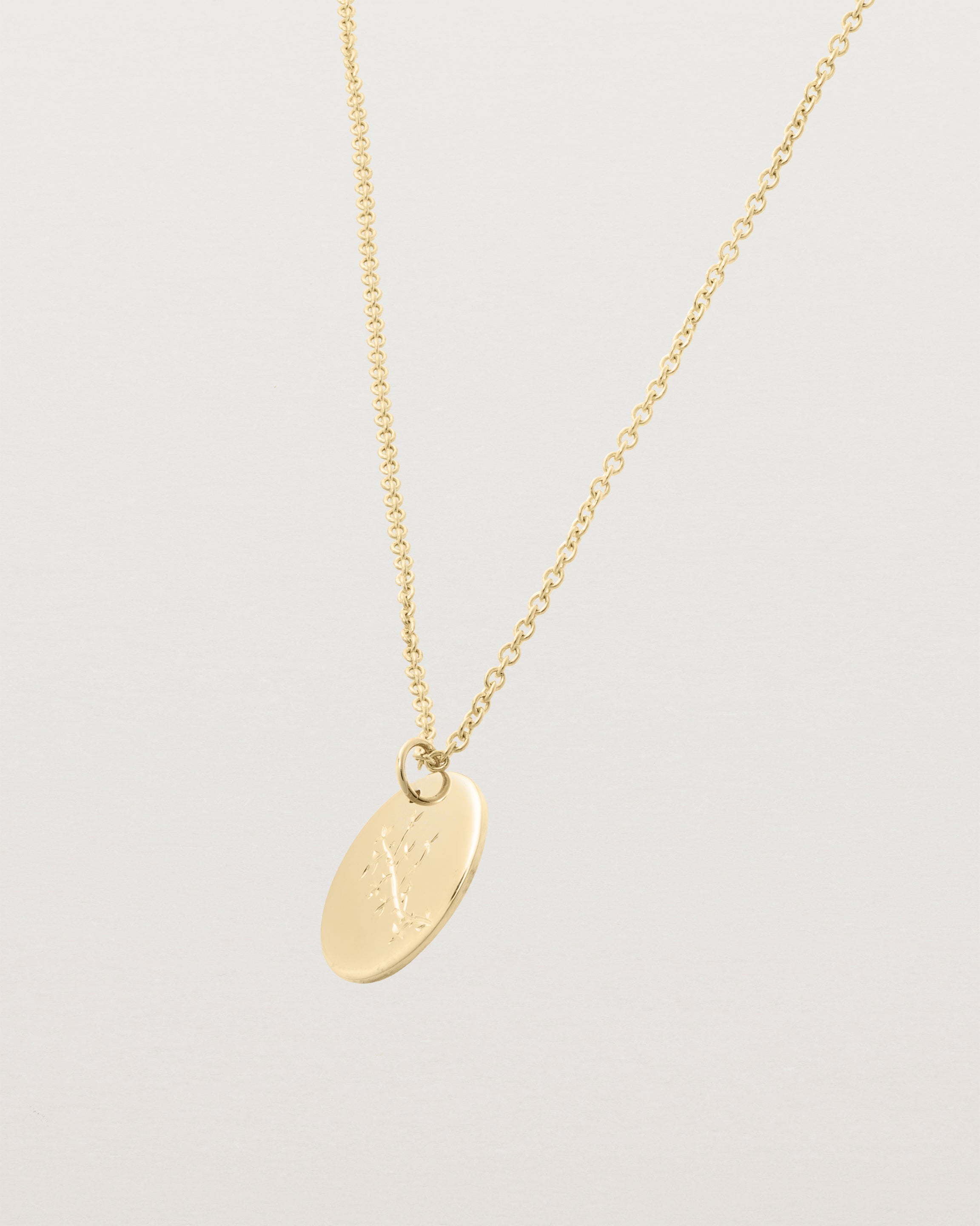 yellow gold engraved necklace with a botanical vine engraving