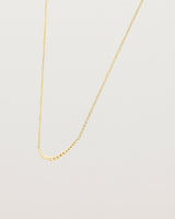 Angled view of the Crescent Necklace in yellow gold.