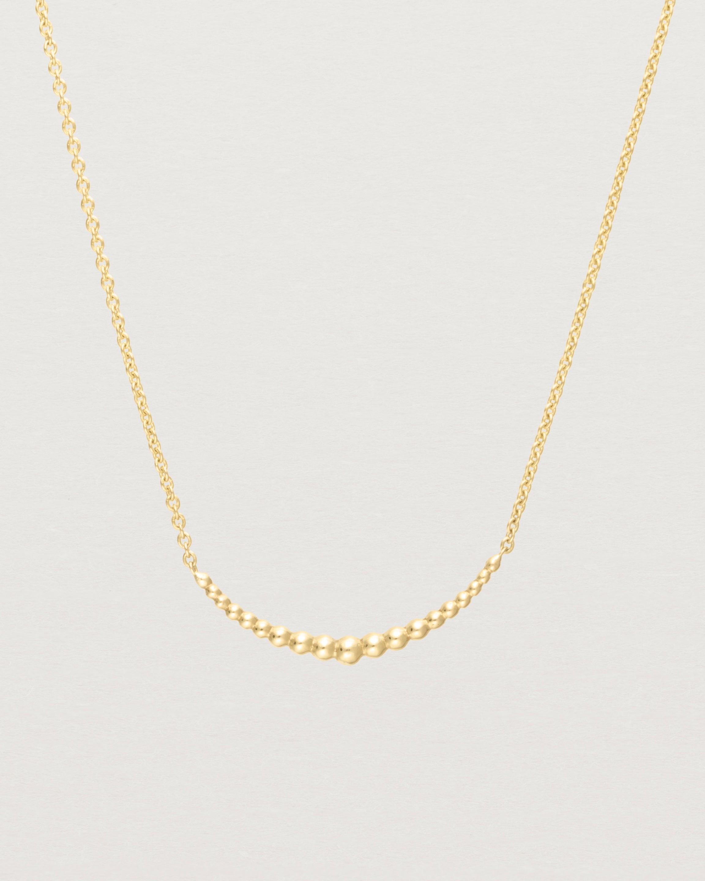 Close up of the Crescent Necklace in yellow gold.