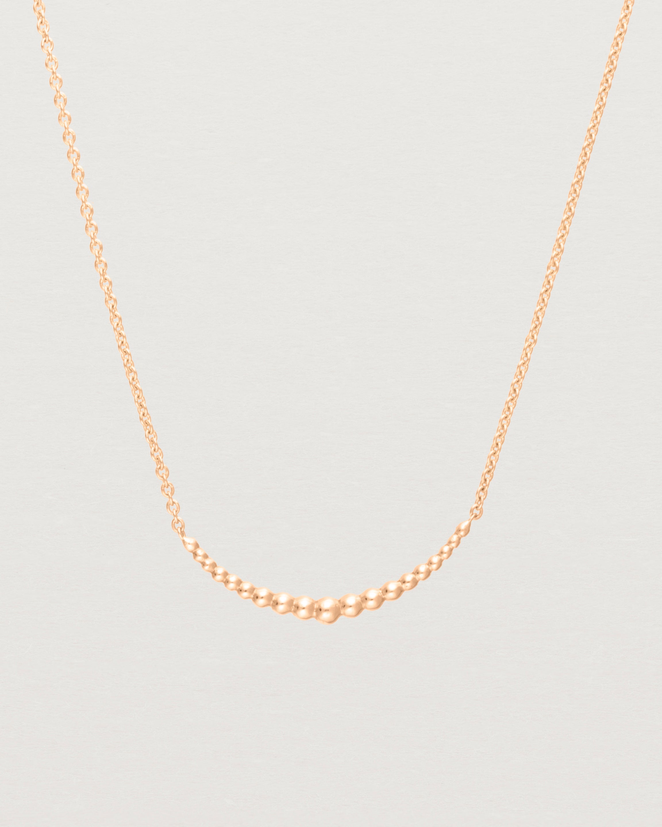 Close up view of the Crescent Necklace in Rose Gold. 