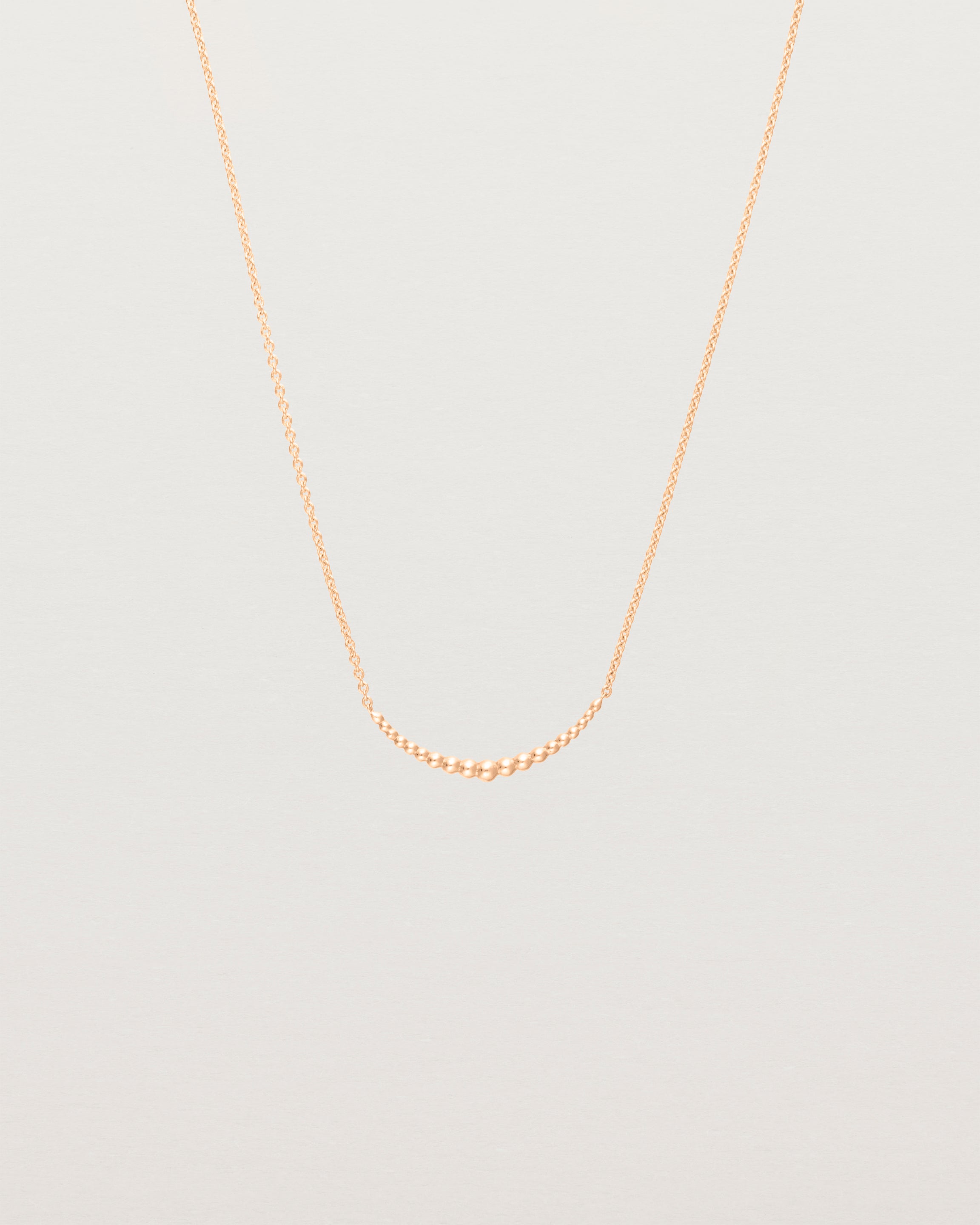 Front view of the Crescent Necklace in Rose Gold.