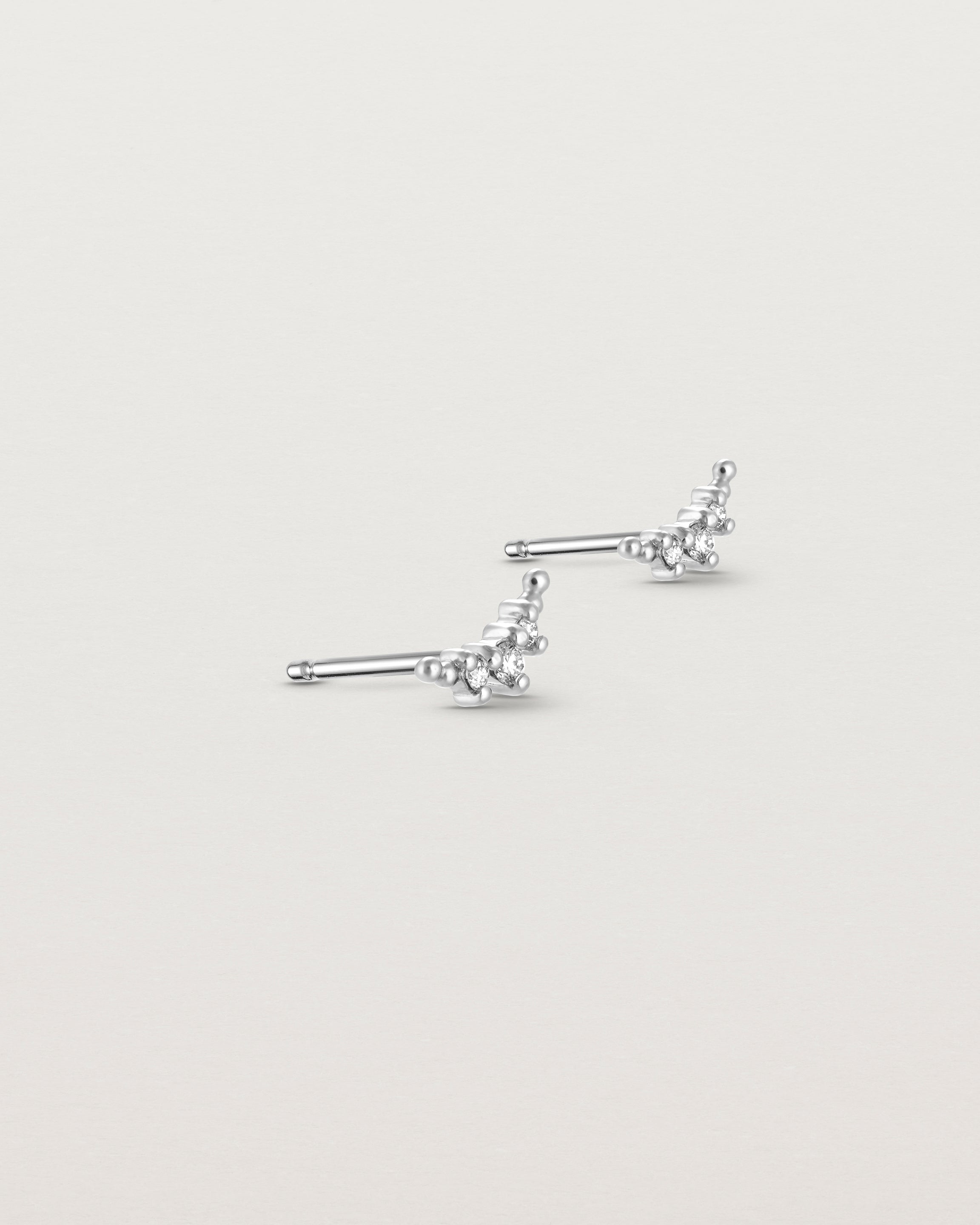 Angled view of the Crescent Studs | Diamonds in white gold.