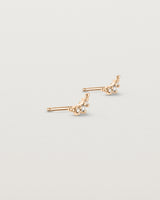Angled view of the Crescent Studs | Diamonds in rose gold.