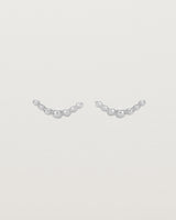 A pair of sterling silver studs featuring an arc of round metal balls
