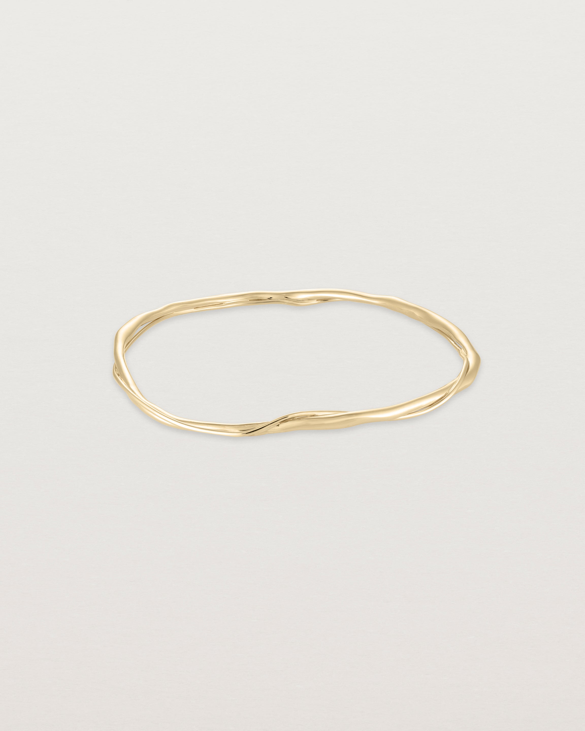 Front view of the Dalí Bangle in yellow gold