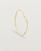 Standing view of the Dalí Bangle in yellow gold
