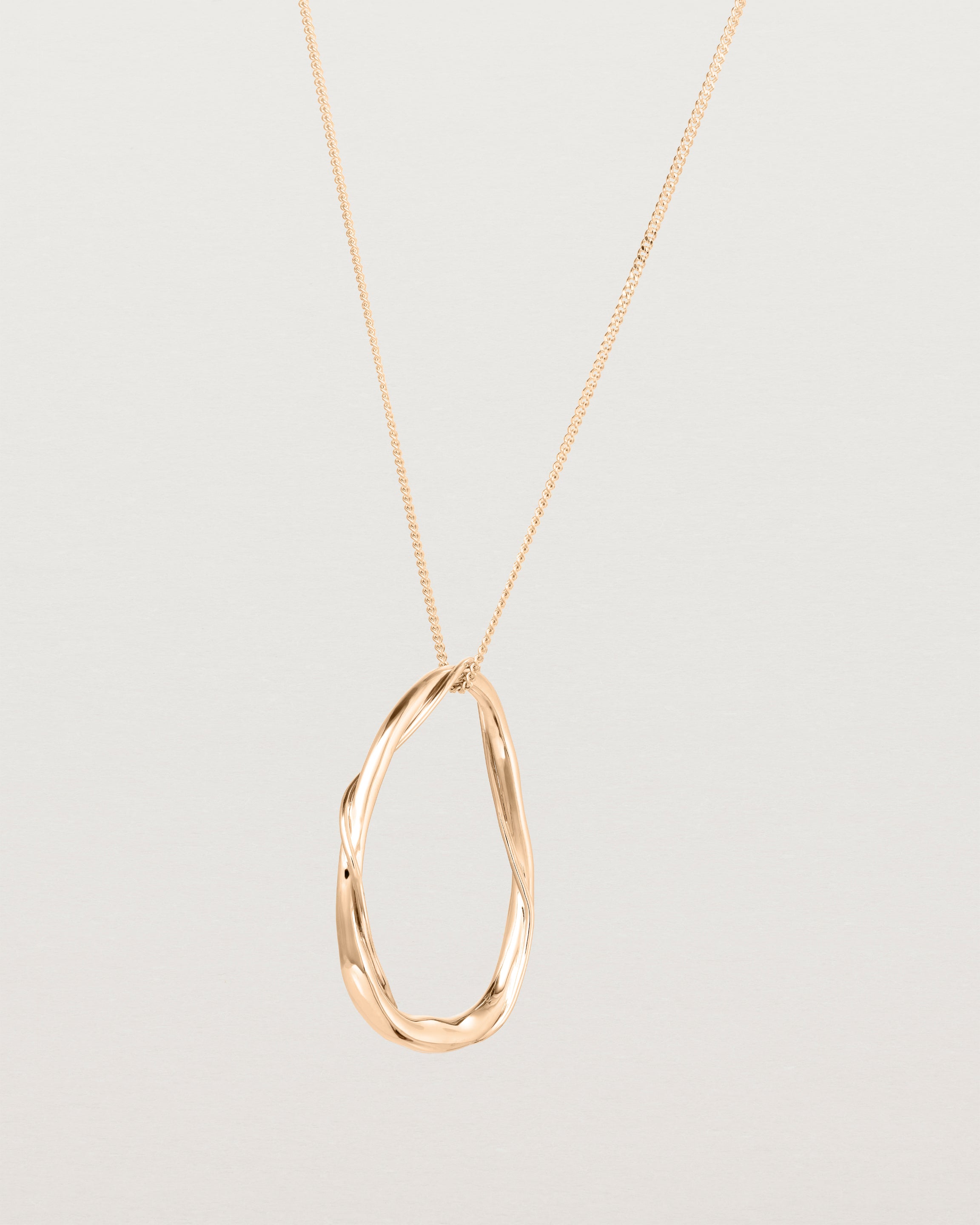 Angled view of the Dalí Necklace in rose gold.