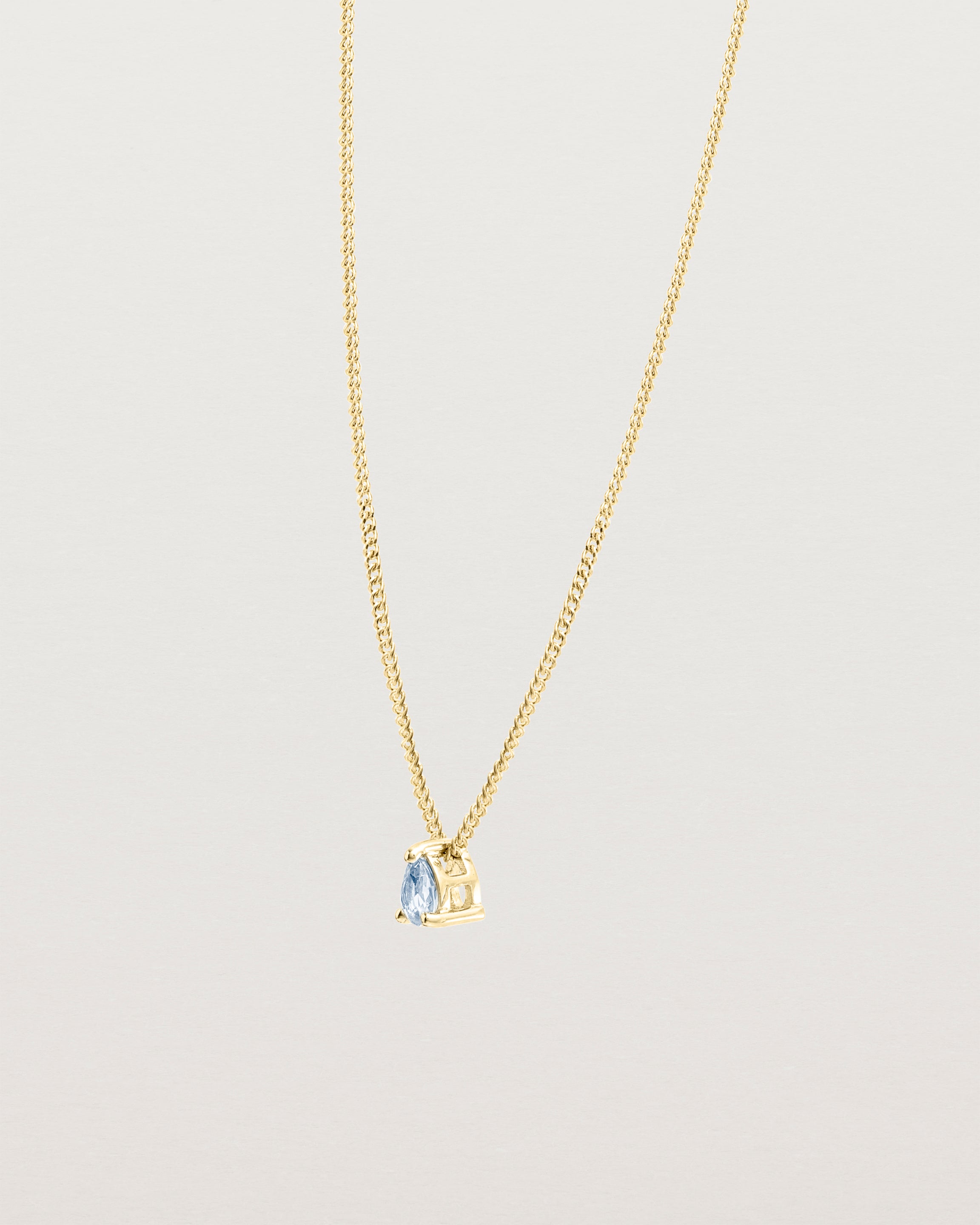 Angled view of the Danaë Slider Pendant | Sapphire | Yellow Gold.