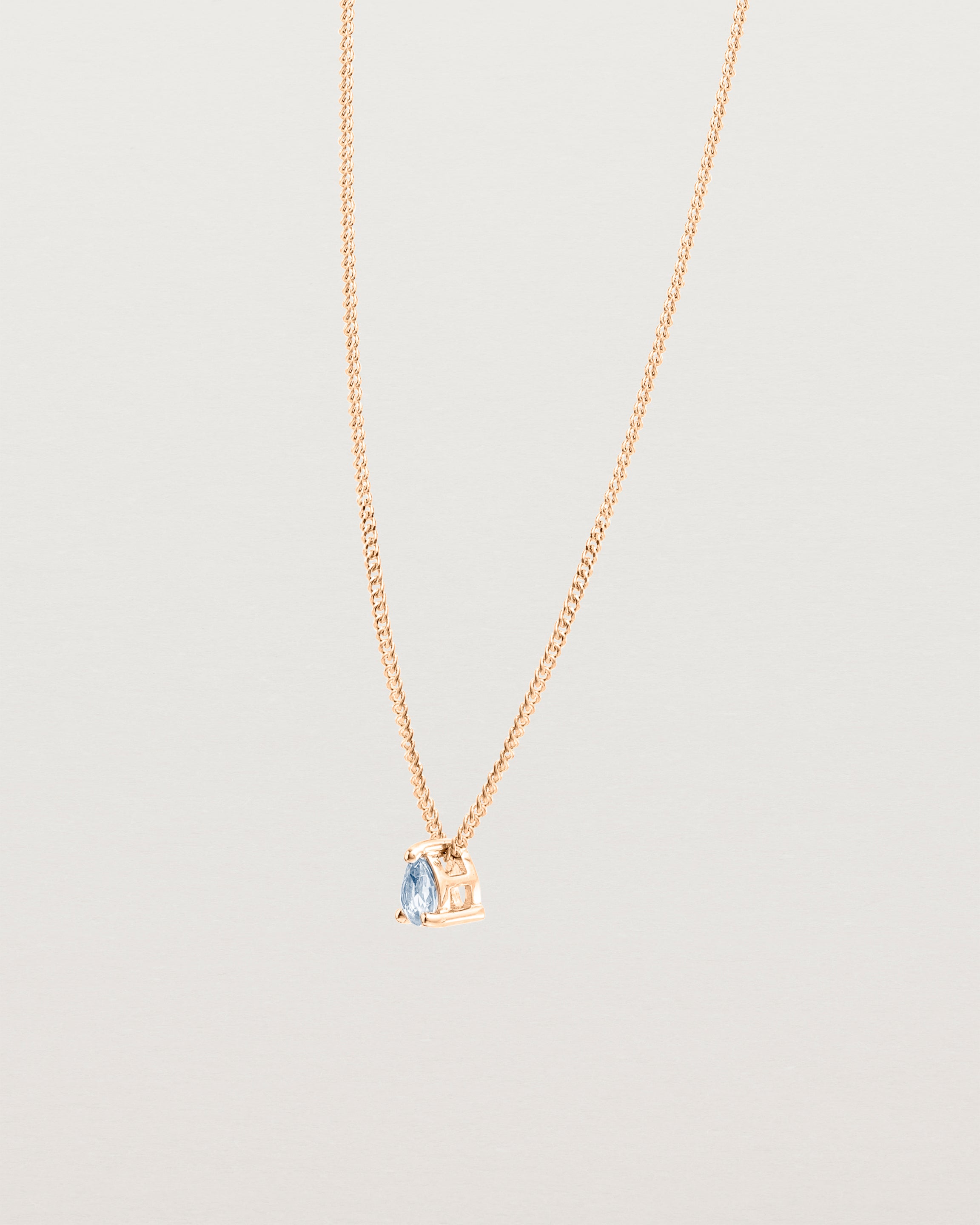 Angled view of the Danaë Slider Pendant | Sapphire | Rose Gold.