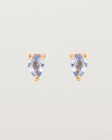 A pair of rose gold studs featuring a pear cut pale blue sapphire