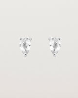 a pair of white gold studs featuring a pear cut diamond