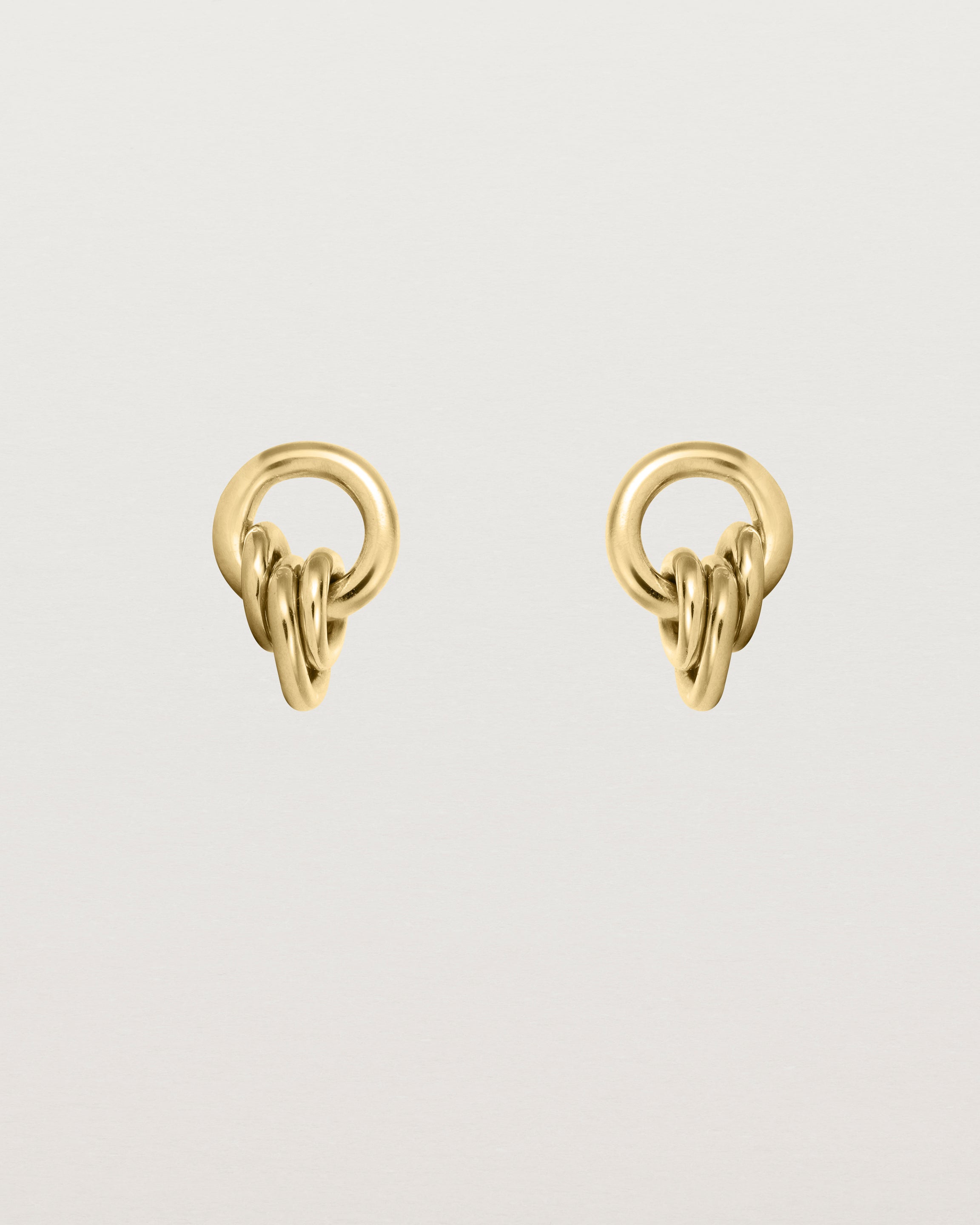 A pair of yellow gold studs with three mini hoops attached