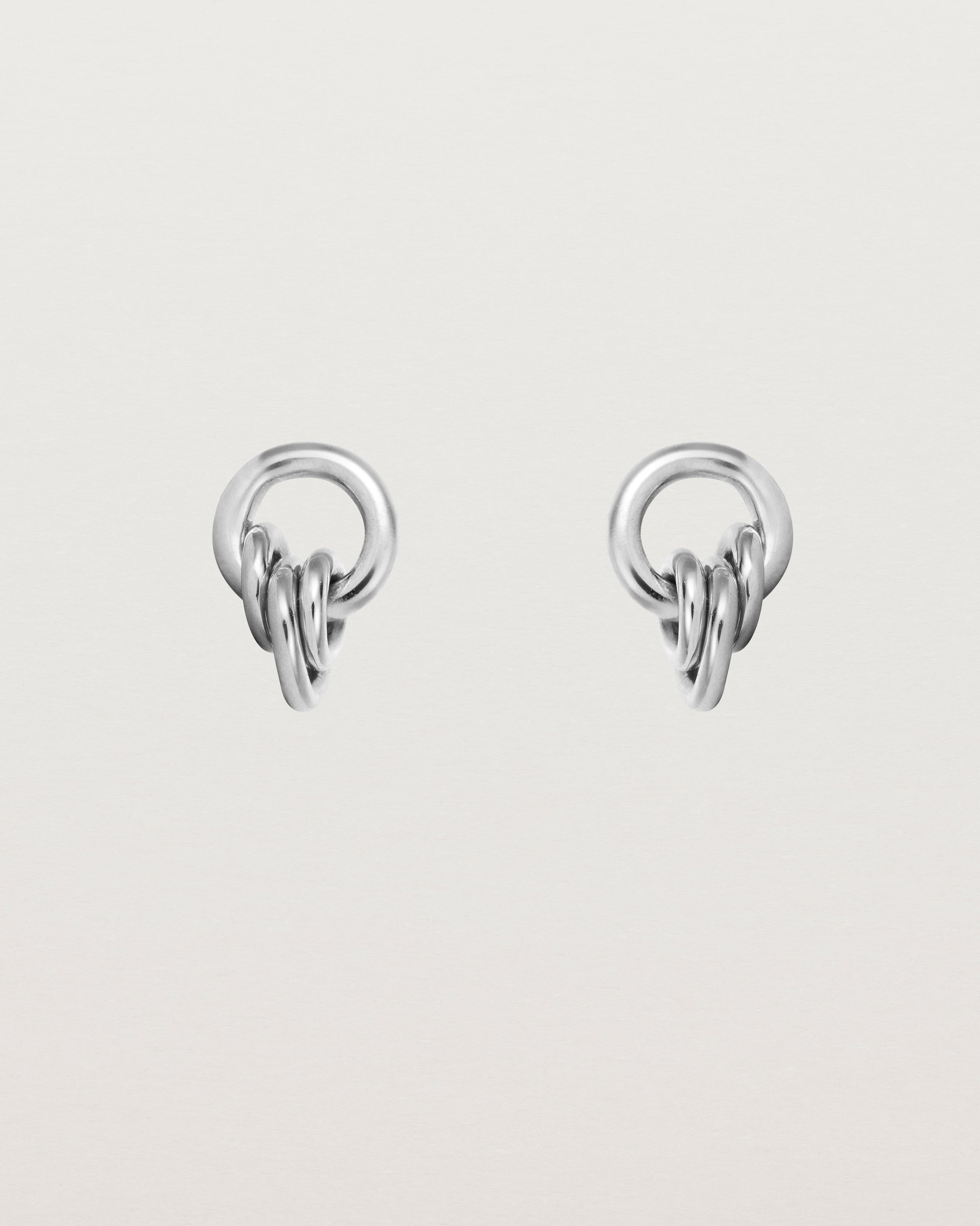 A pair of sterling silver studs with three mini hoops attached