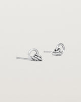 A pair of sterling silver studs with three mini hoops attached