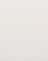 A pair of yellow gold studs featuring a cluster of four diamonds