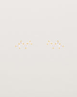 A pair of yellow gold studs featuring a cluster of four diamonds