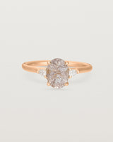 An oval Rutilated Quartz adorned with white diamonds either side, featuring a sweeping setting and crafted in rose gold