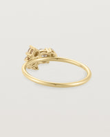 Back view of a white diamond cluster ring in yellow gold