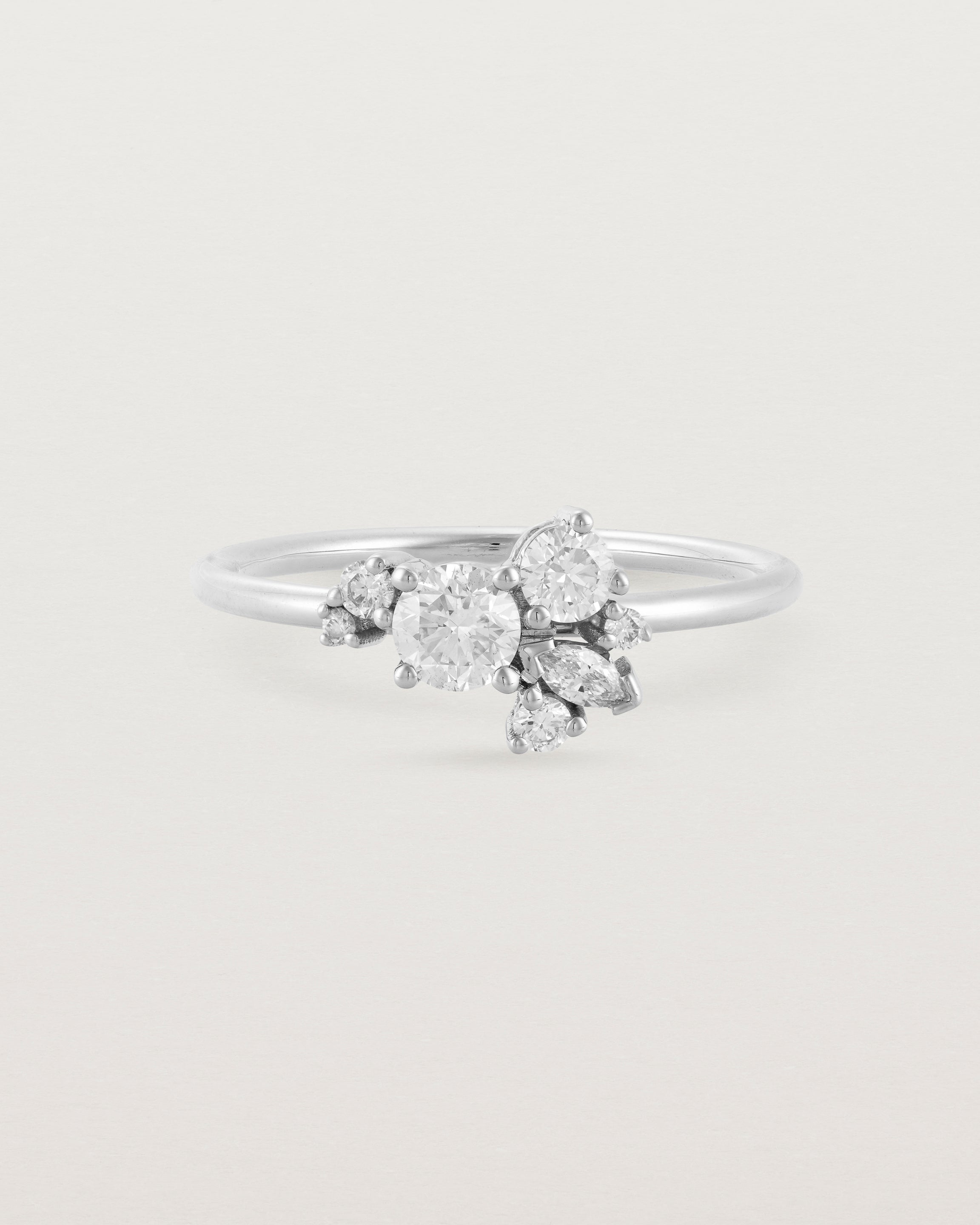 Front view of a white diamond cluster ring in white gold