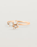 Side view of a white diamond cluster ring in rose gold
