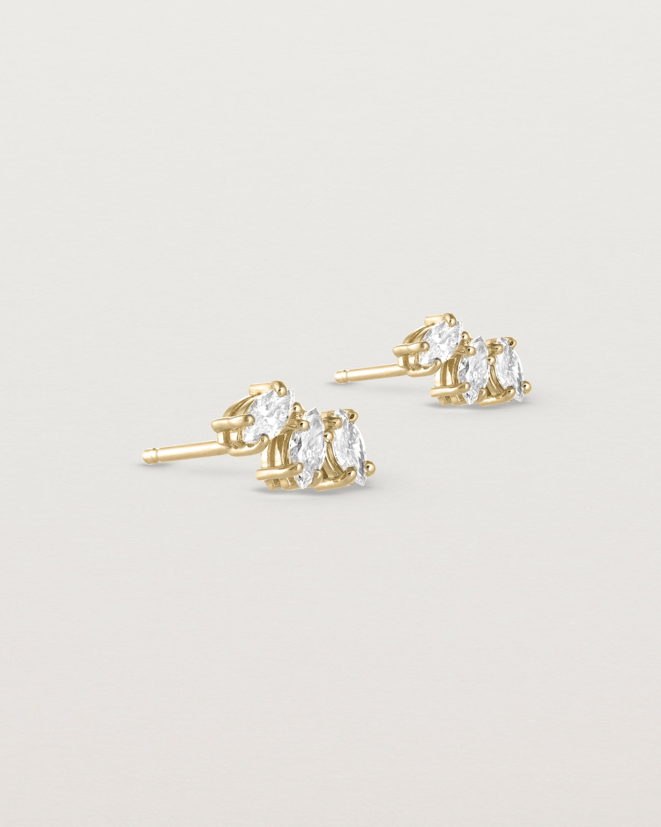 Angled view of the Sun Studs | Diamonds in yellow gold.