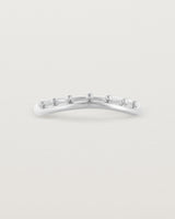 A gentle arc ring featuring dot detailing along the top of the arc, crafted in white gold.