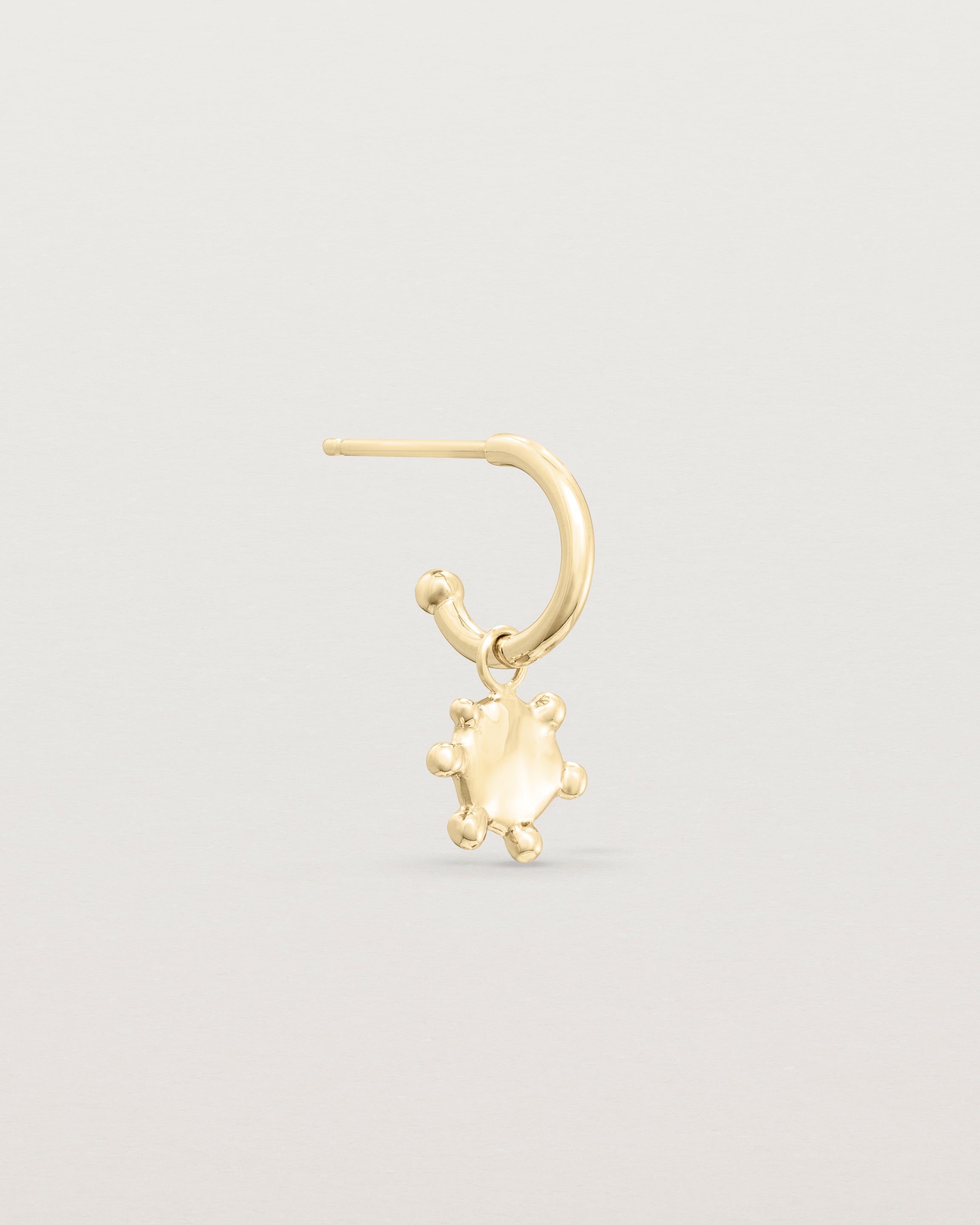 Single view of the Dotted Mana Hoop in yellow gold.