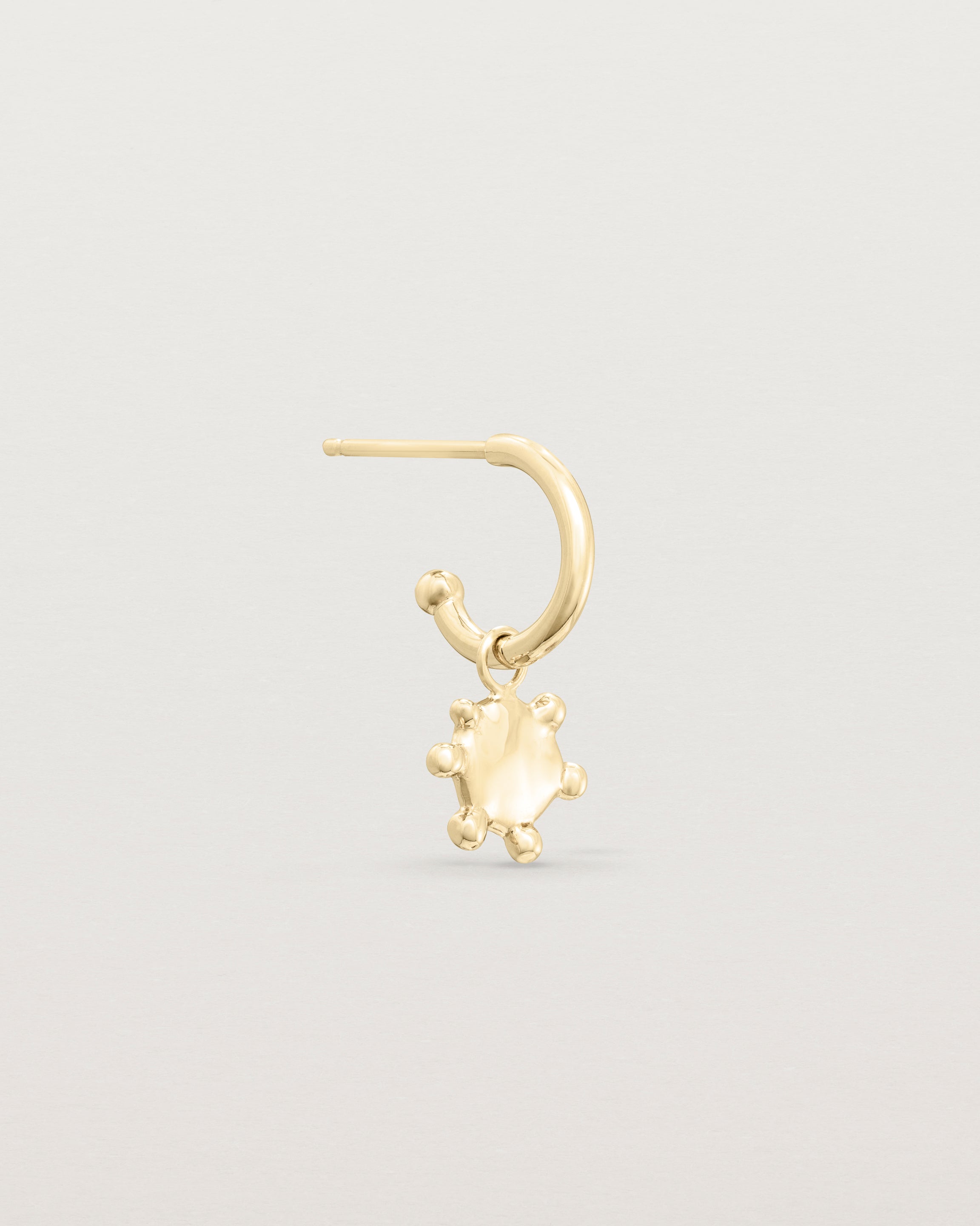 Single view of the Dotted Mana Hoop in yellow gold.