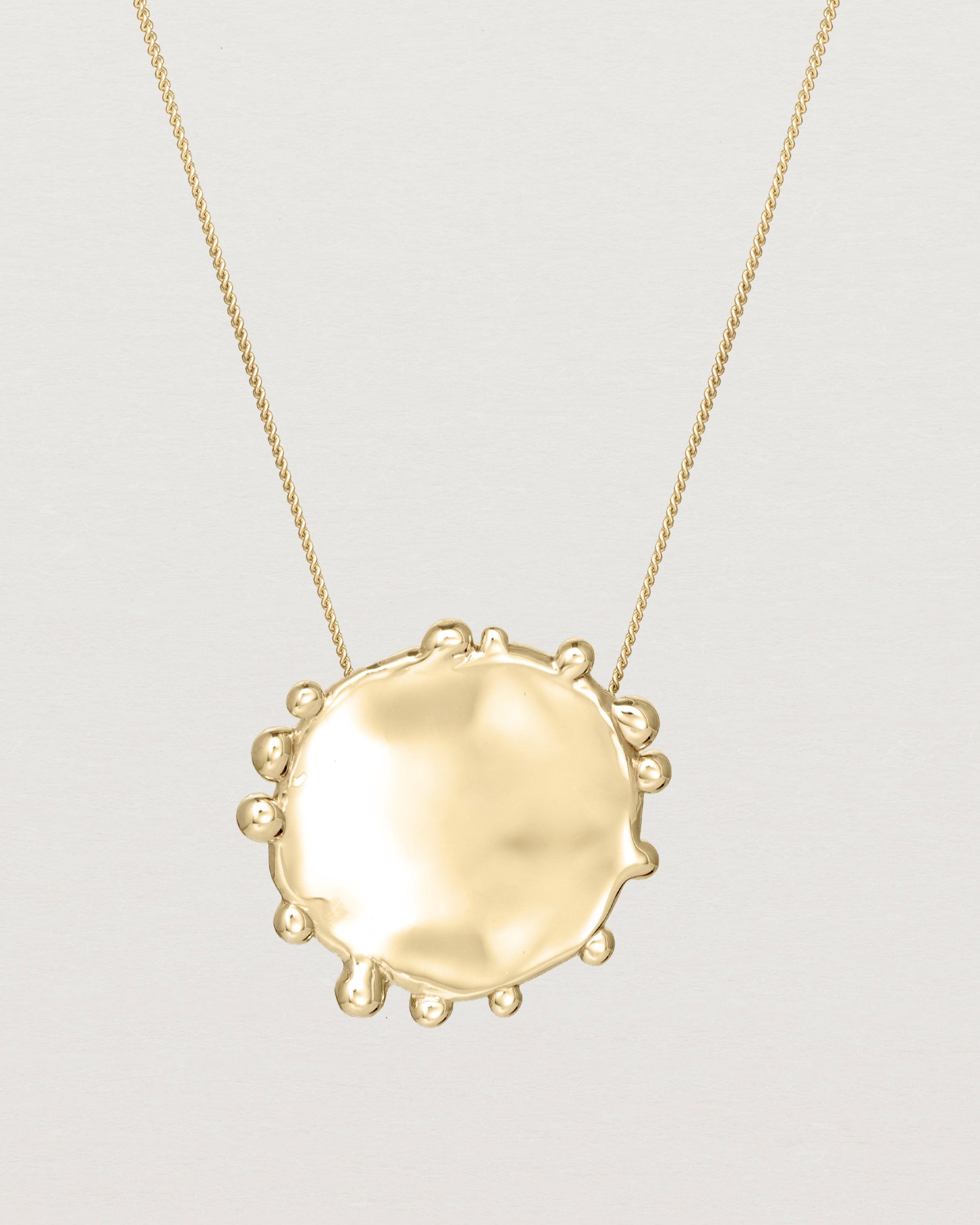 Close up of the Dotted Mana Necklace in yellow gold