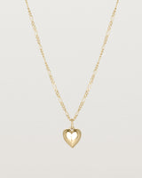 A solid heart is suspended from our fine Figaro Chain in yellow gold