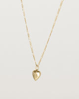 Angled view of the Ella Necklace with a star set diamond birthstone in yellow gold.