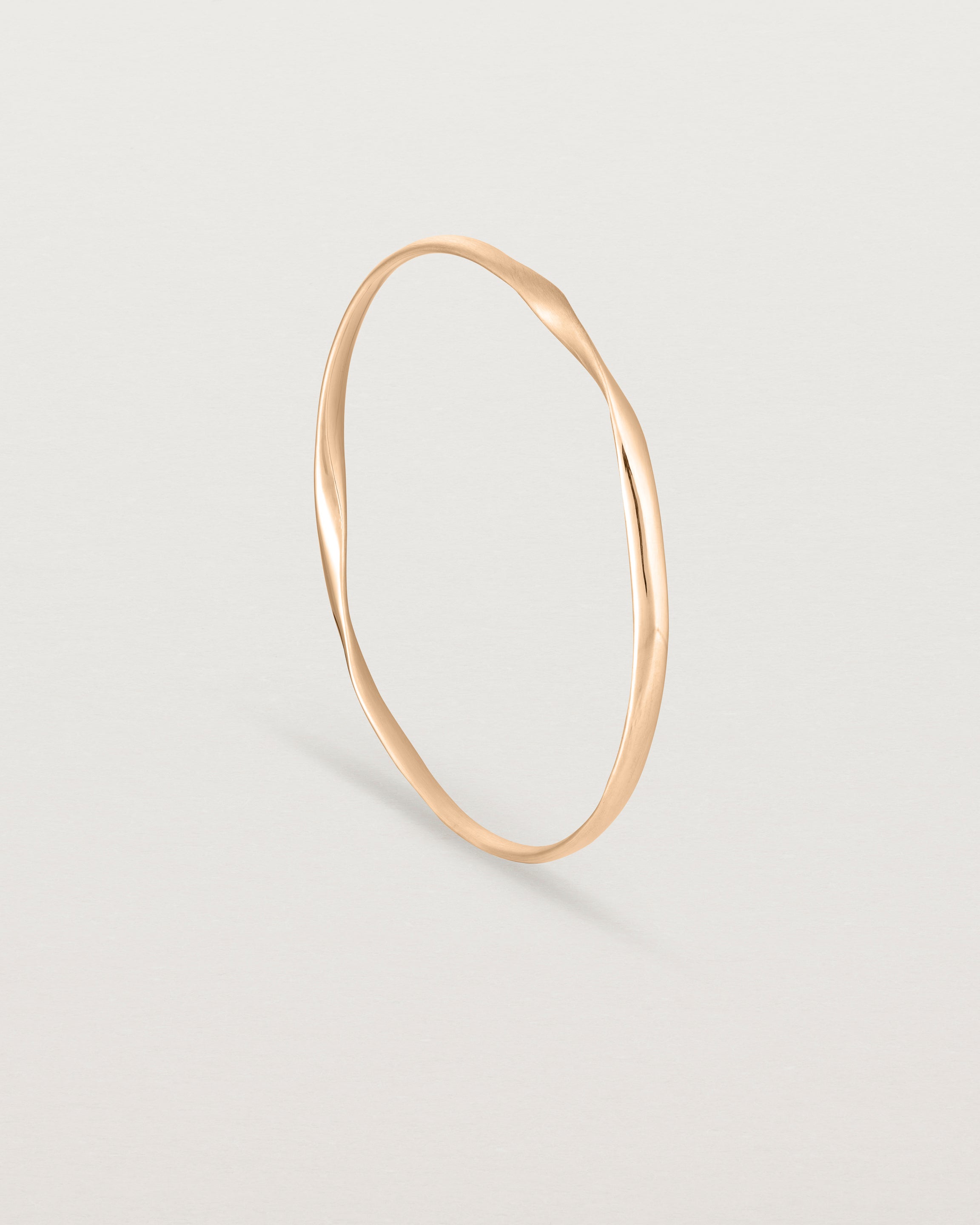standing view of the ellipse bangle in rose gold