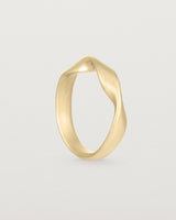 Standing view of the Ellipse / Shift Ring in Yellow Gold.