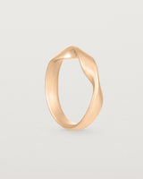 Standing view of the Ellipse / Shift Ring in Rose Gold.