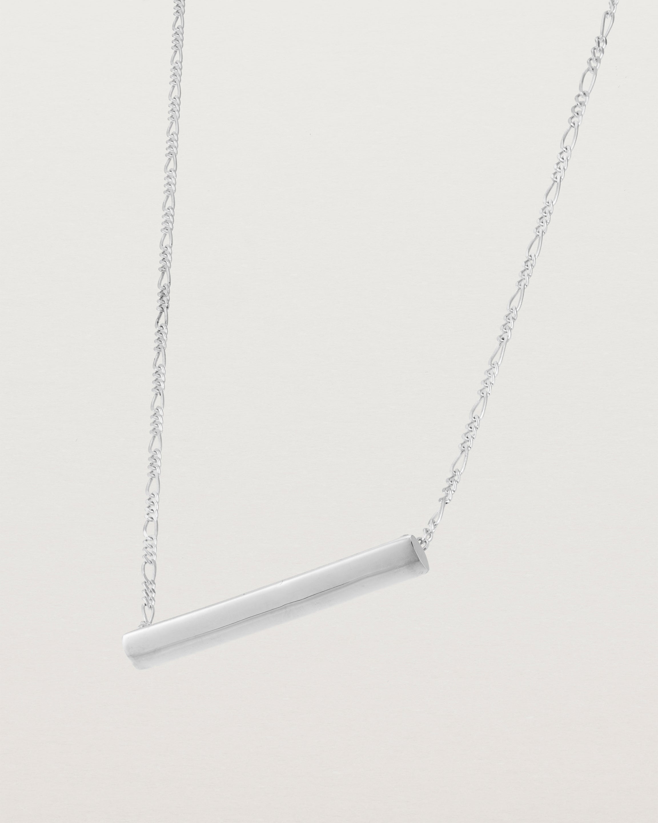 side view of Ellipse necklace with a silver bar hanging from a chain in sterling silver